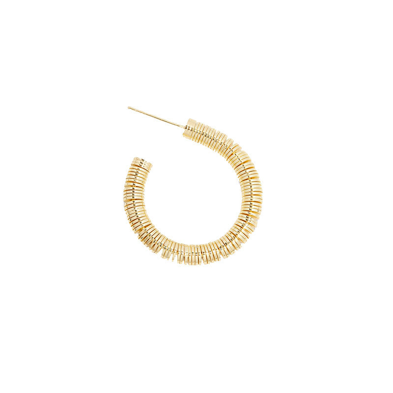 Gold hoop earring on a white background
