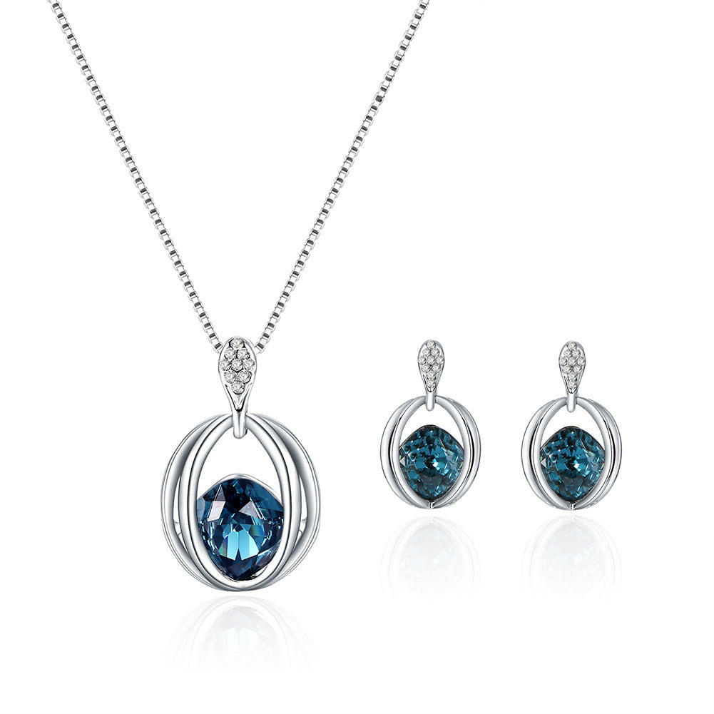 Silver jewelry set with blue gemstones on a white background