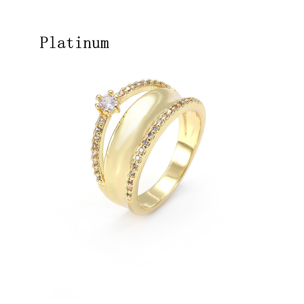 Gold ring with a central gemstone on a white background, labeled 'Platinum'.
