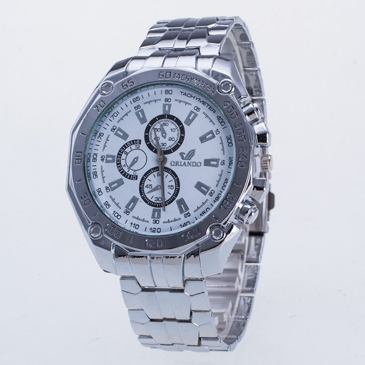 Silver wristwatch with a detailed face on a light blue background