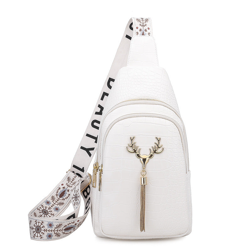 White crossbody bag with deer design and floral strap on a white background