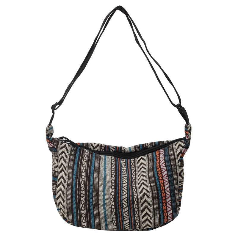 Patterned shoulder bag with a strap on a white background