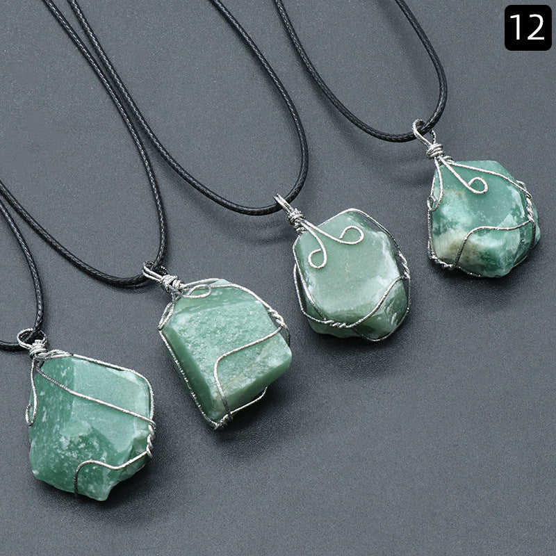 Green stone pendants on black cords against a gray background