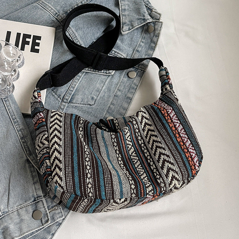 Patterned shoulder bag on a denim jacket with a magazine underneath