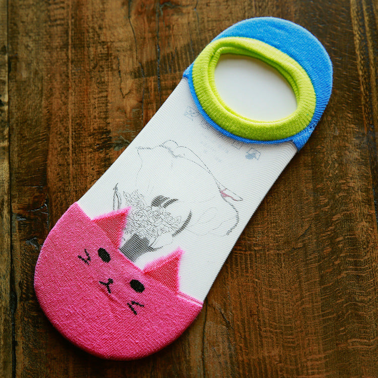 Cat-themed sock with pink bottom and blue top on a wooden surface