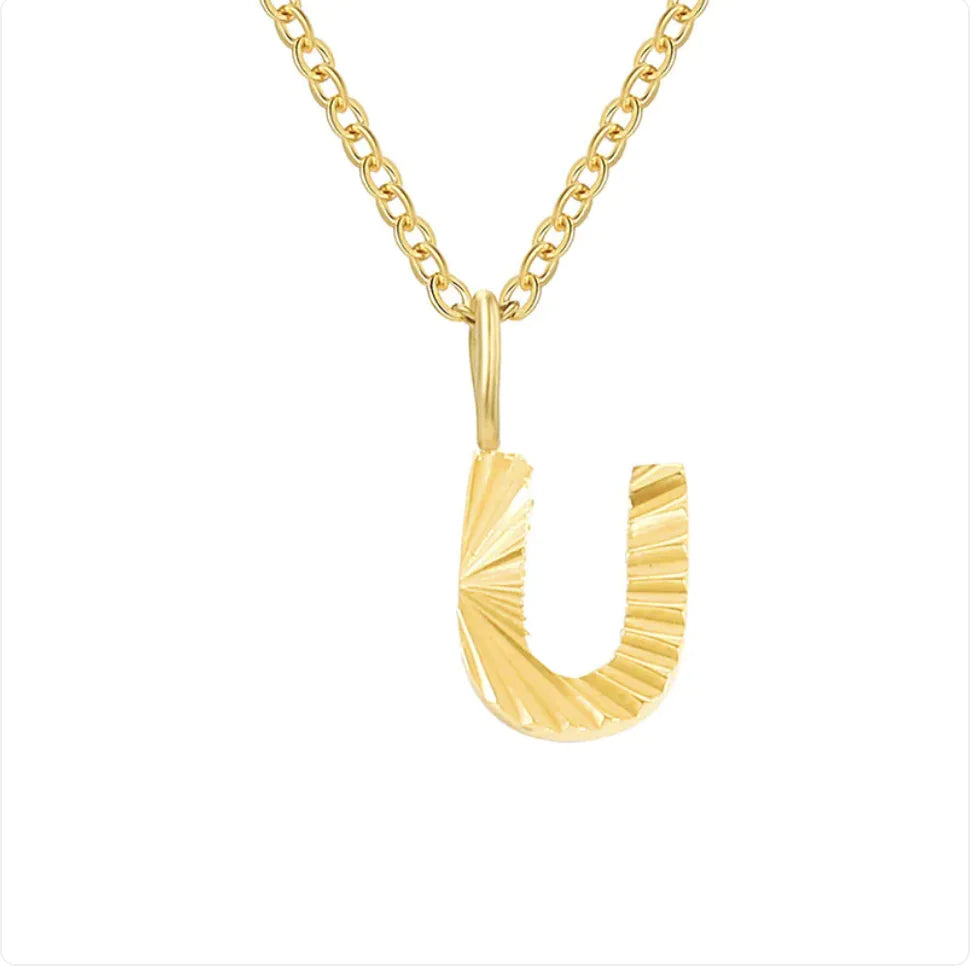 Gold necklace with a unique pendant on a white background