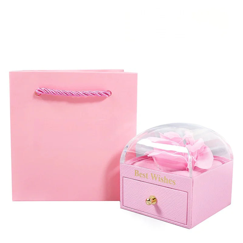 Pink jewelry box with a clear lid and 'Best Wishes' text, next to a matching pink card on a white background.