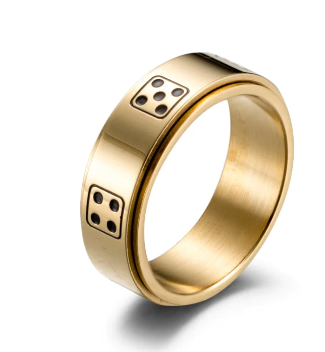 Gold ring with dice design on a white background