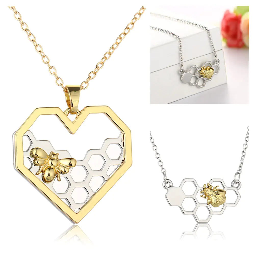 Gold and silver honeycomb necklace with bee pendant on a white background
