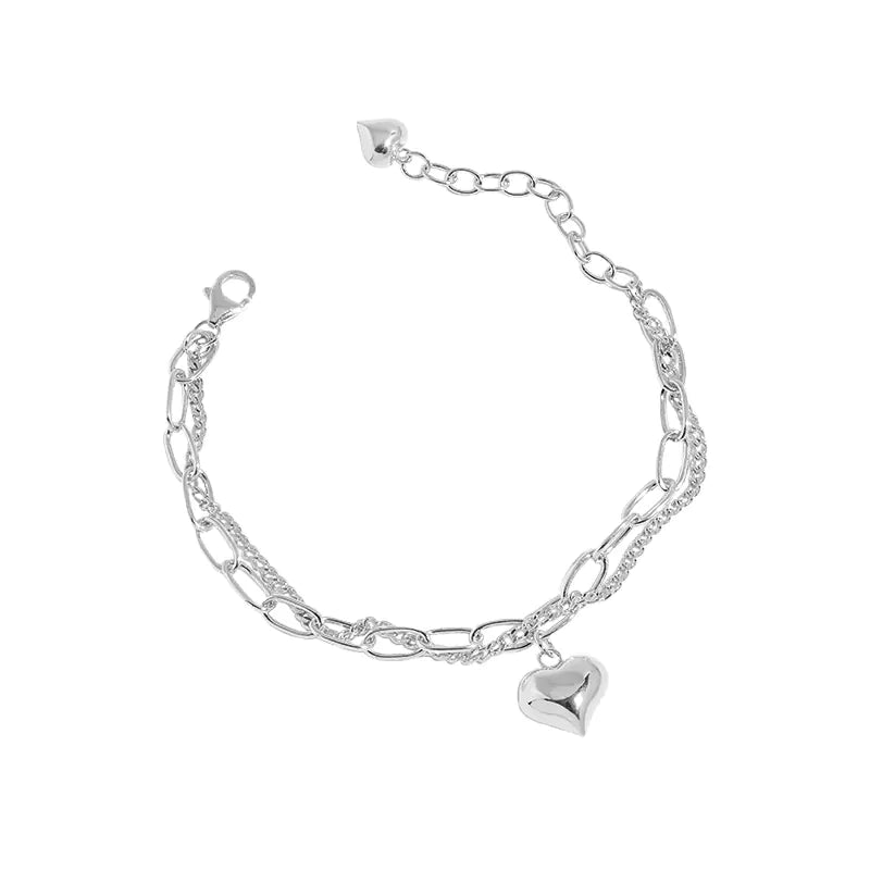 Silver chain bracelet with a heart-shaped charm on a white background