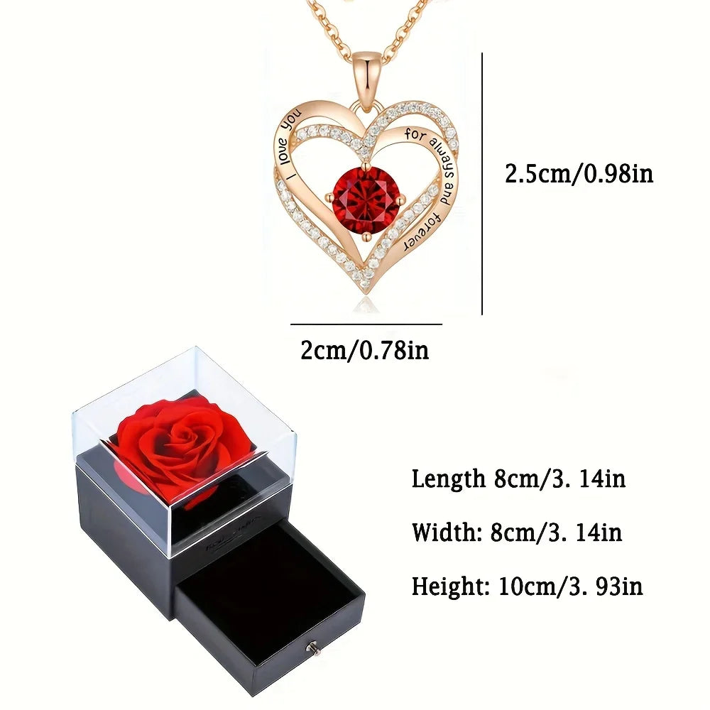 Heart-shaped pendant necklace with red gemstone and rose in clear box, measurements displayed.