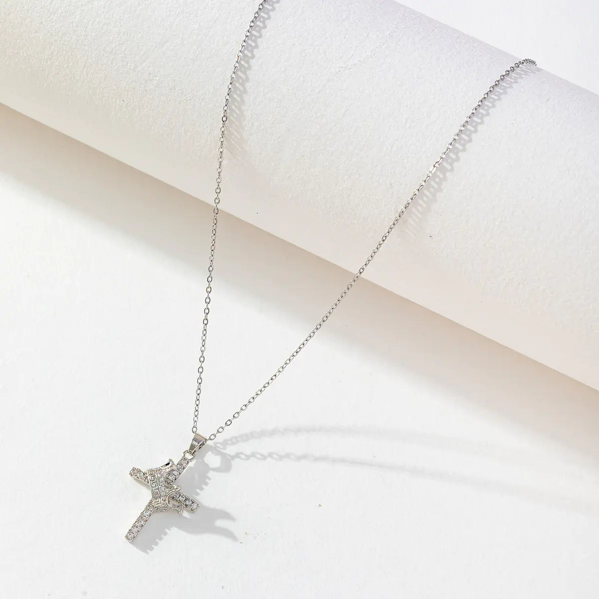 Silver star-shaped pendant necklace on a white background