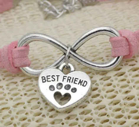 Bracelet with infinity symbol and 'Best Friend' heart charm on pink cord