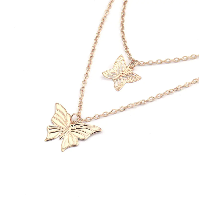 Rose gold butterfly necklace on a white background