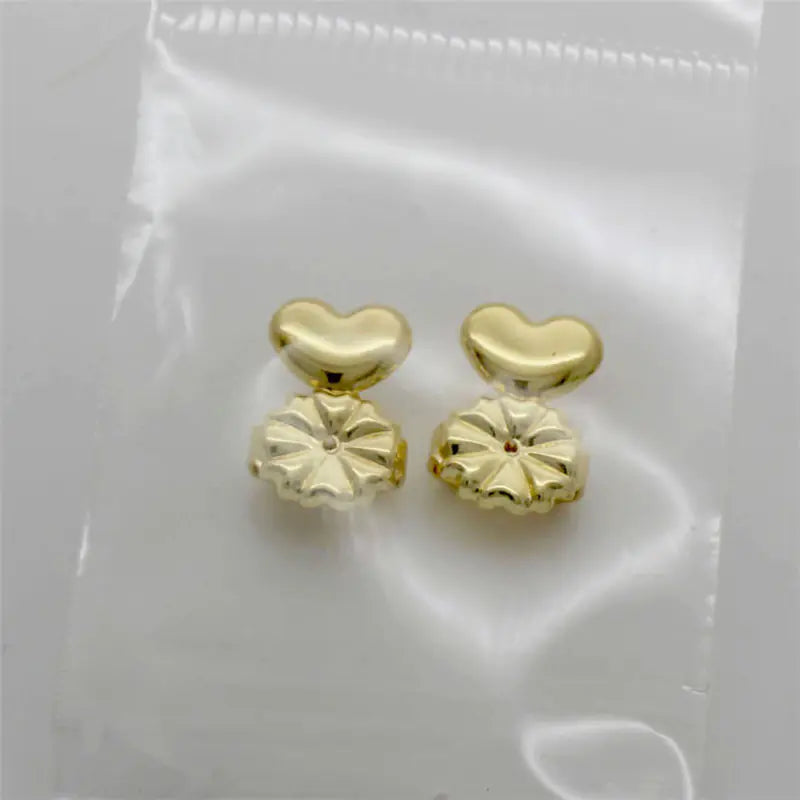 Gold heart-shaped earrings on a white background