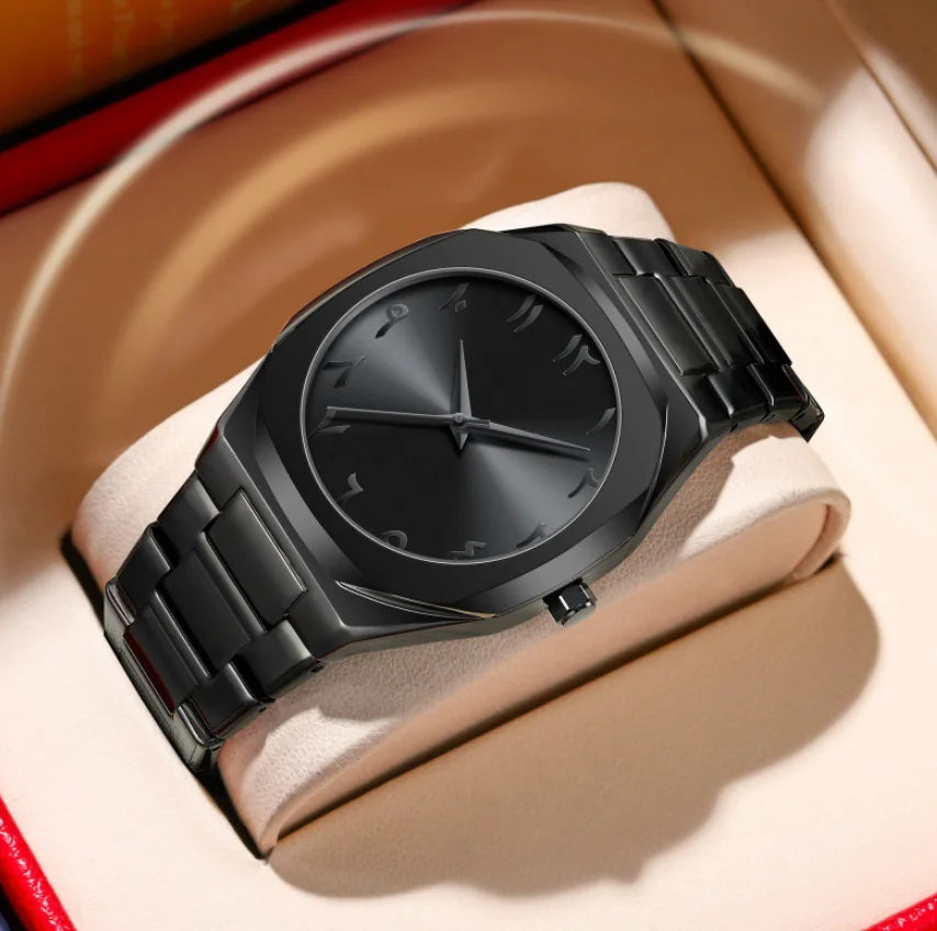 Black wristwatch with a metallic band on a beige cushion