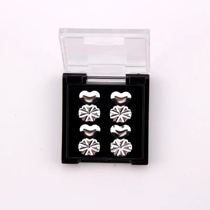 Set of silver heart-shaped earrings in a clear packaging box on a white background