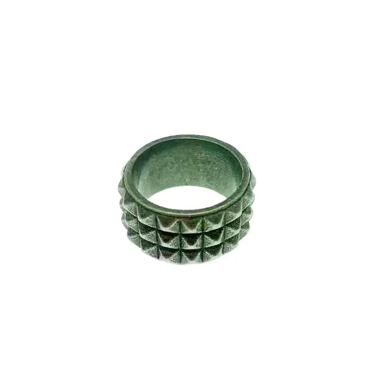 Metallic ring with textured design on a white background