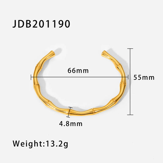 Gold bracelet with measurements on a white background