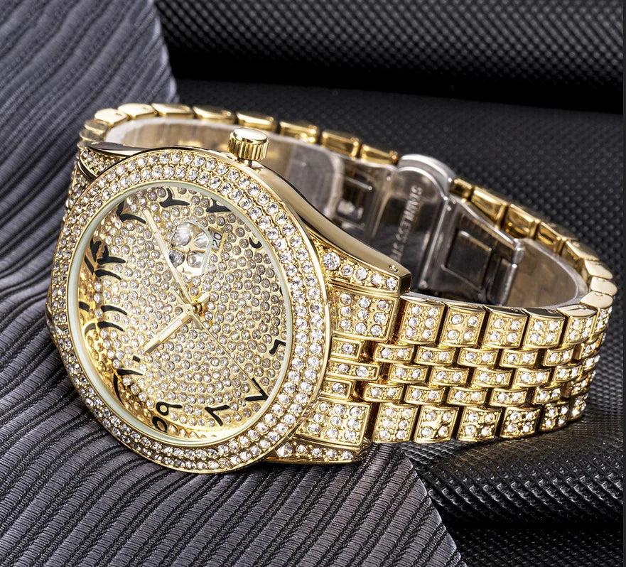 Gold watch with diamond-studded face and band on a textured surface