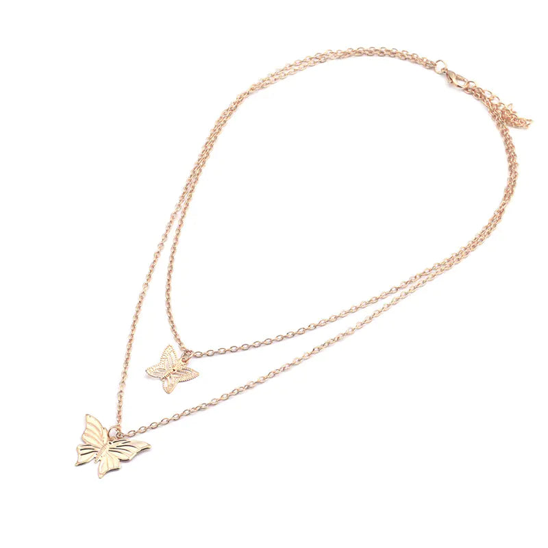 Rose gold butterfly necklace on a white background