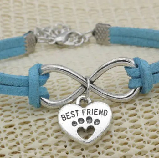 Bracelet with blue strap and silver 'Best Friend' charm on a textured beige background