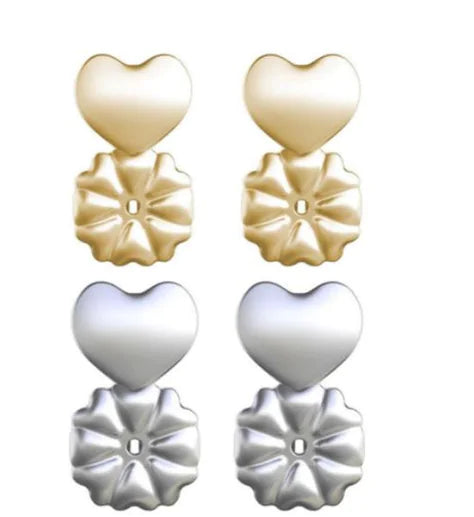 Pair of heart-shaped earrings in gold and silver on a white background