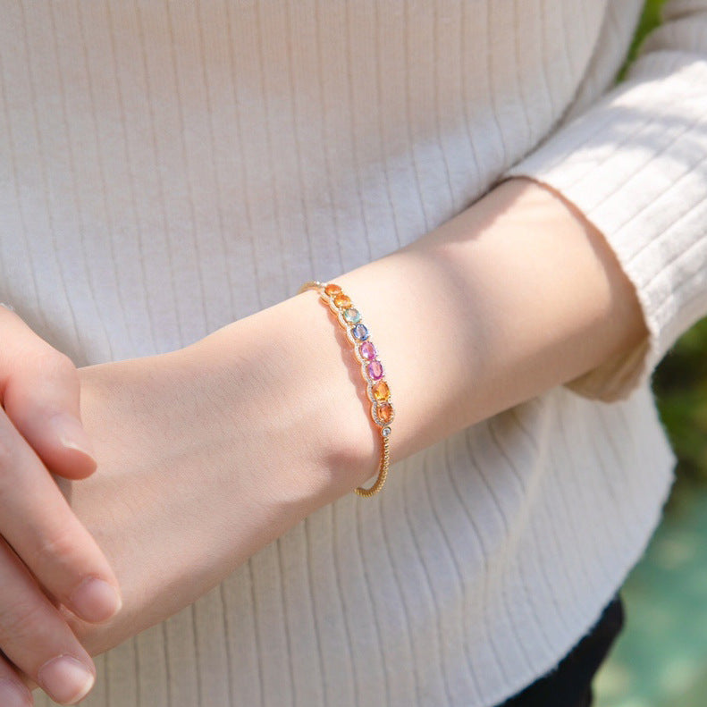 Multicolored beaded bracelet on a wrist with a blurred background