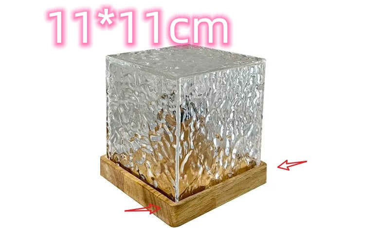 Decorative glass block with wooden base, size indicated as 11*11cm.
