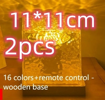 Small glowing light with text indicating size, quantity, color options, and remote control on a wooden base.