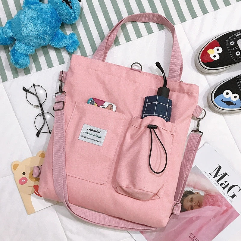 Pink tote bag with a small umbrella on a striped background