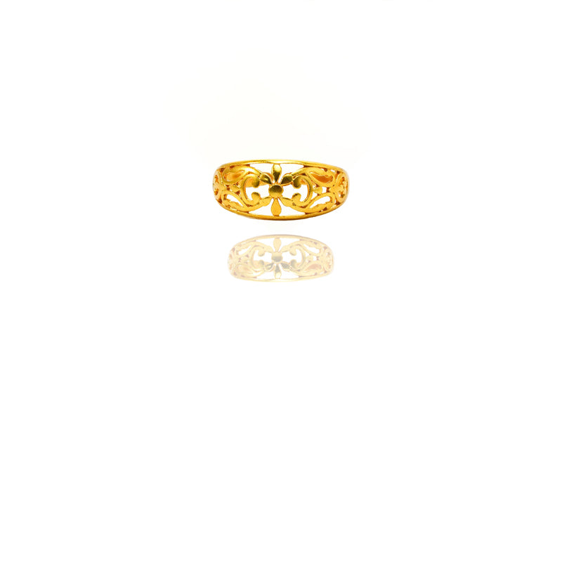 Gold ring with intricate design on a white background