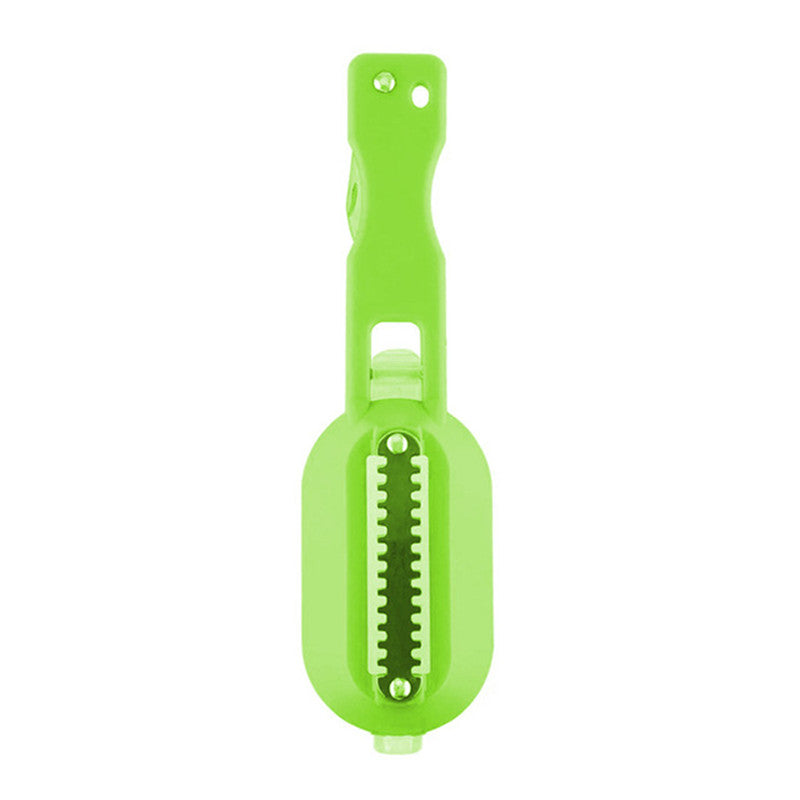 Green vegetable peeler on a white background