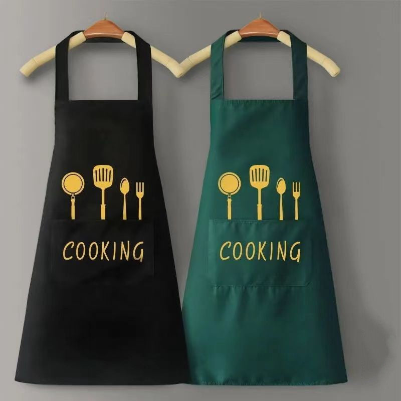 Black and green aprons with 'COOKING' text and utensil icons on a gray background