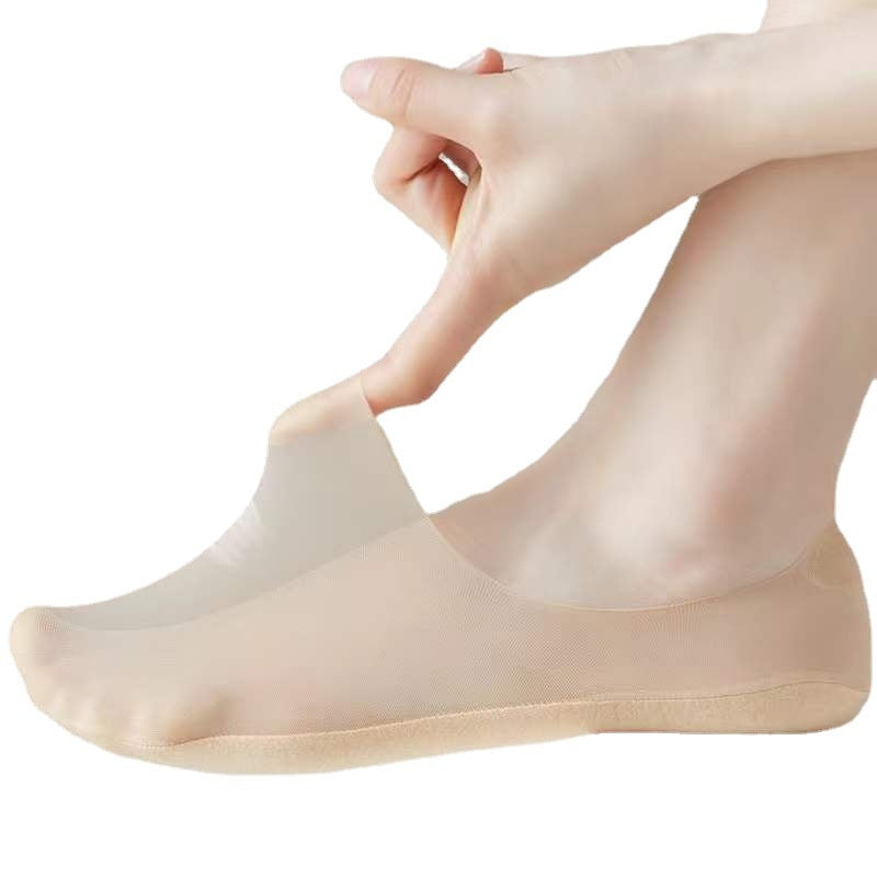 Beige silicone gel pad on a foot against a white background