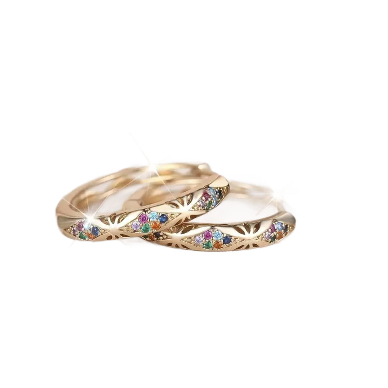 Gold rings with colorful gemstones on a white background