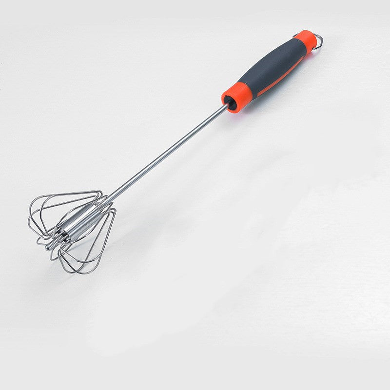 Metal whisk with black and orange handle on a white background