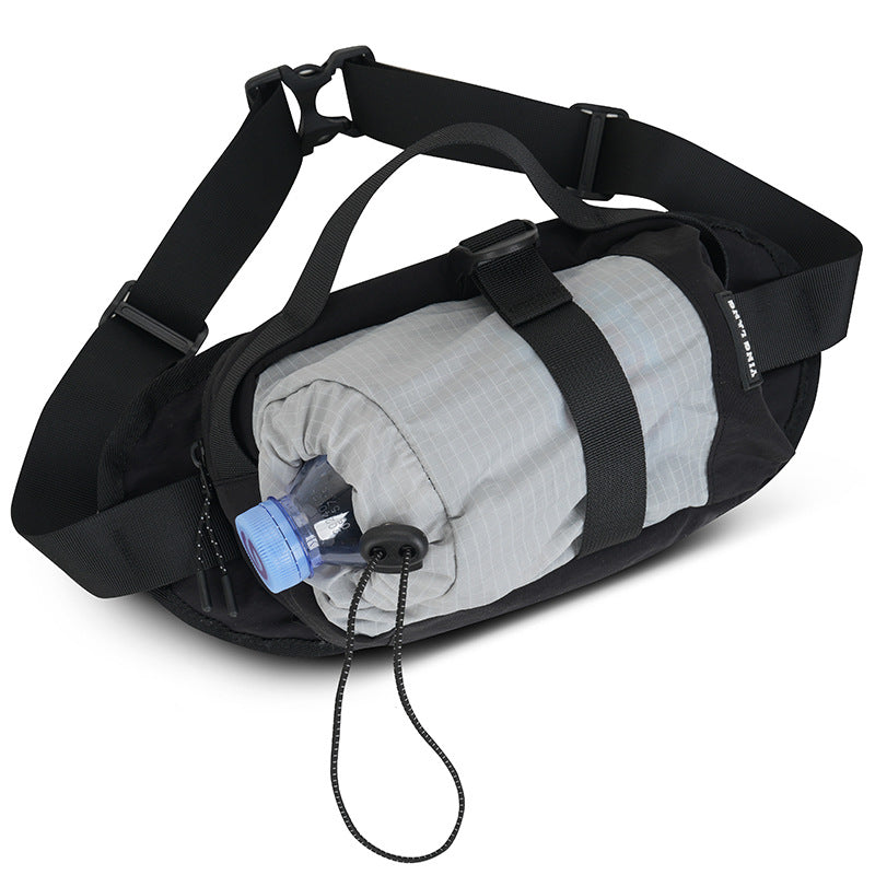 Black waist bag with gray interior and blue water bottle on a white background