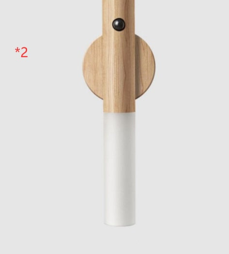 Wooden and white cylindrical object on a light gray background