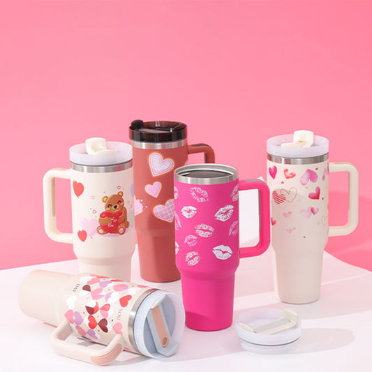 Set of pink and white tumblers with various designs on a pink background