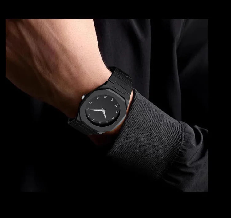 Black wristwatch on a person's wrist with a dark background