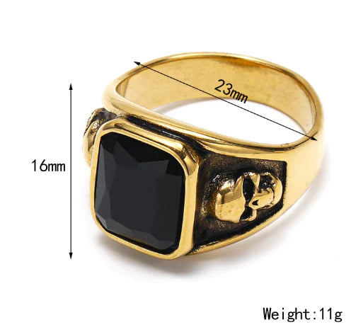 Gold ring with black stone and measurements on a white background