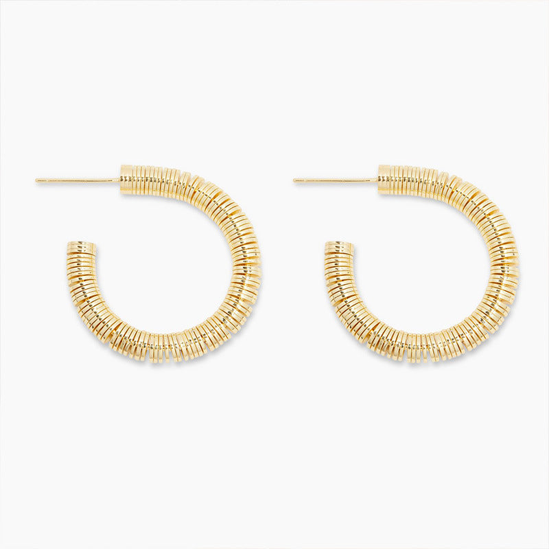 Gold hoop earrings on a white background