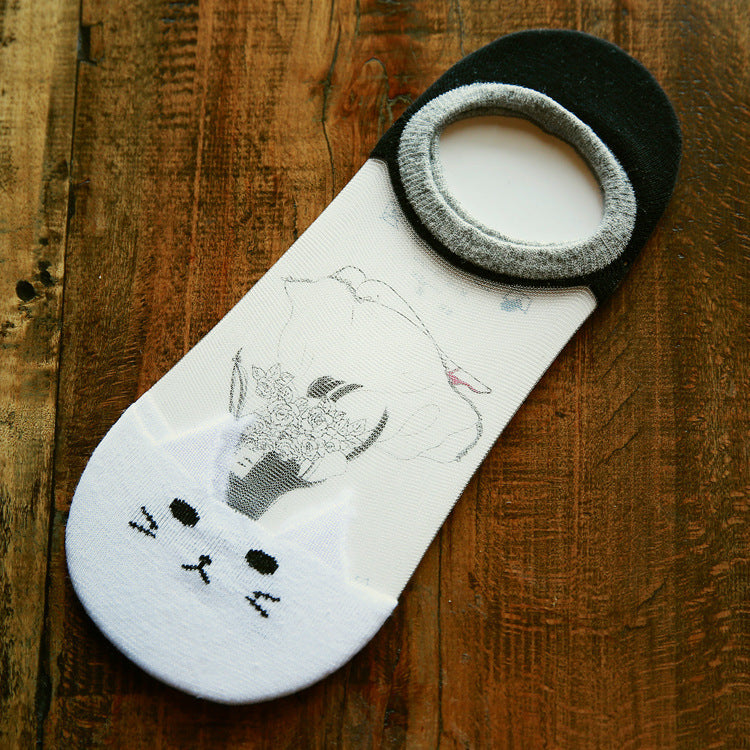 Cat-themed socks on a wooden surface