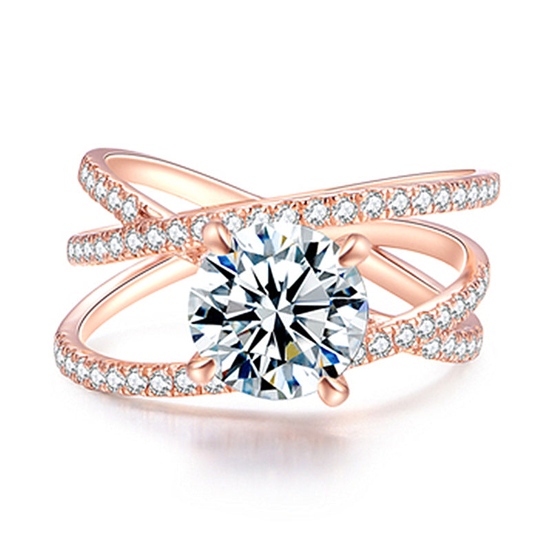 Rose gold ring with a large diamond and smaller diamonds on a white background