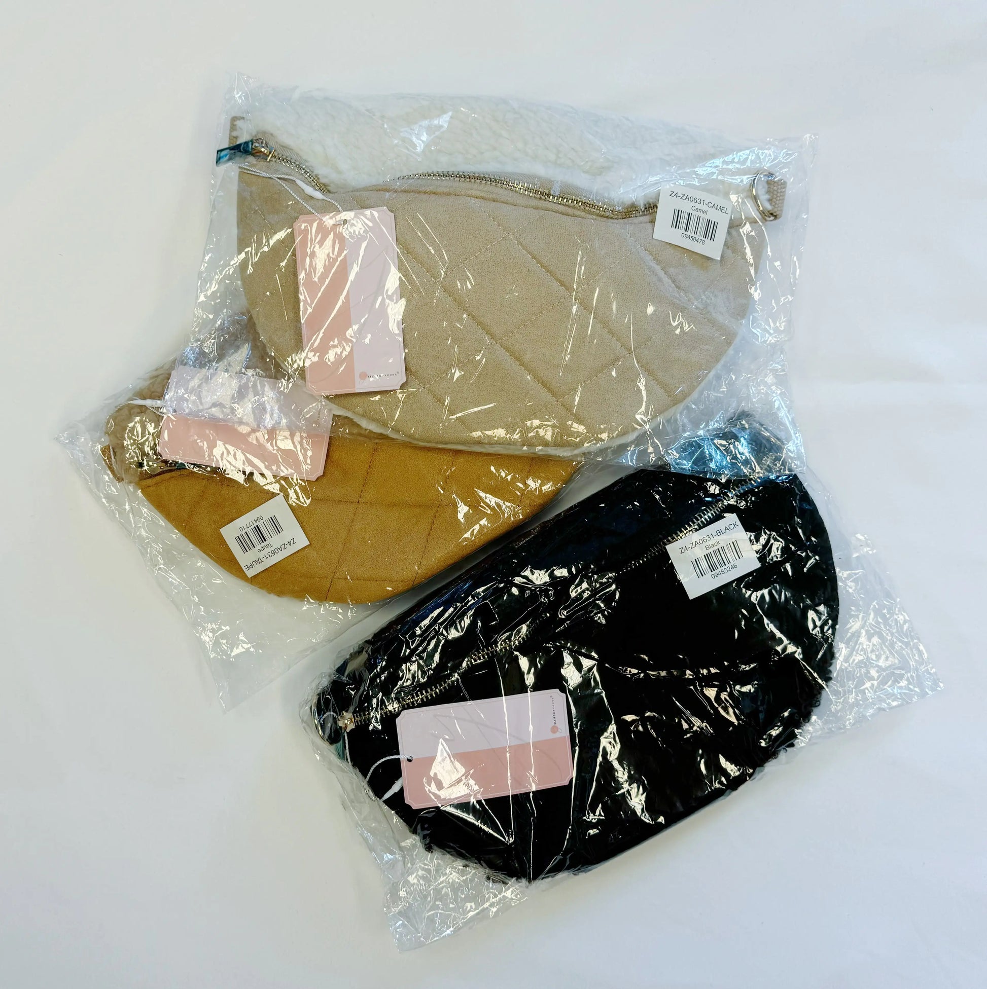 Two quilted bags, one beige and one black, in clear plastic packaging on a white background.