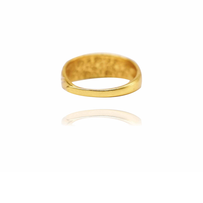 Gold ring with a textured surface on a white background