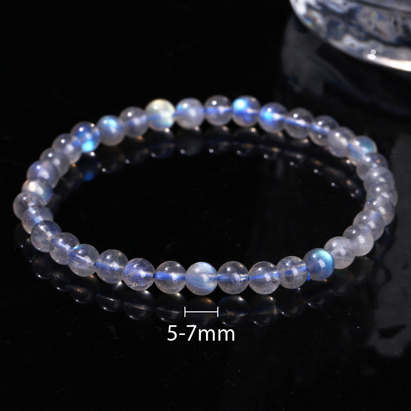 Beaded bracelet with 5-7mm beads on a dark reflective surface