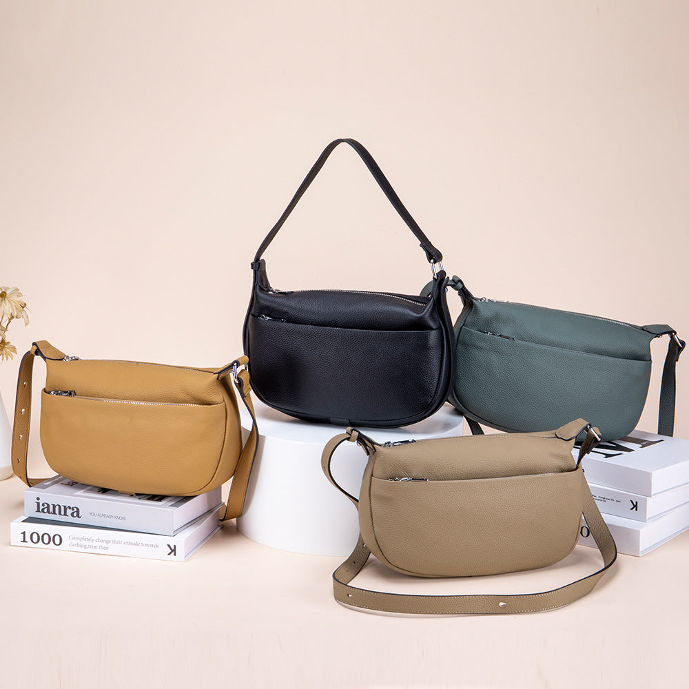 Four handbags in different colors on a light beige background