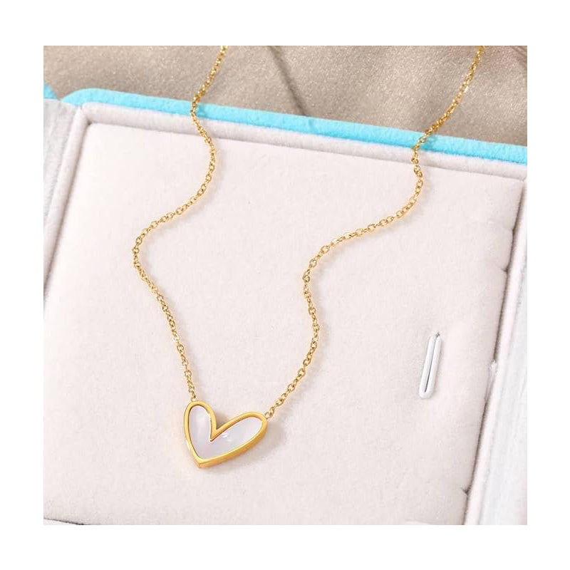 Gold heart-shaped necklace on a white and blue background